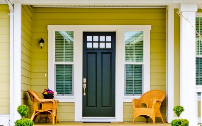 House Entrance With Wicker Chairs And Black Front Door - Feng Shui