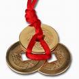 Three coins tied with red ribbon tips for success in business